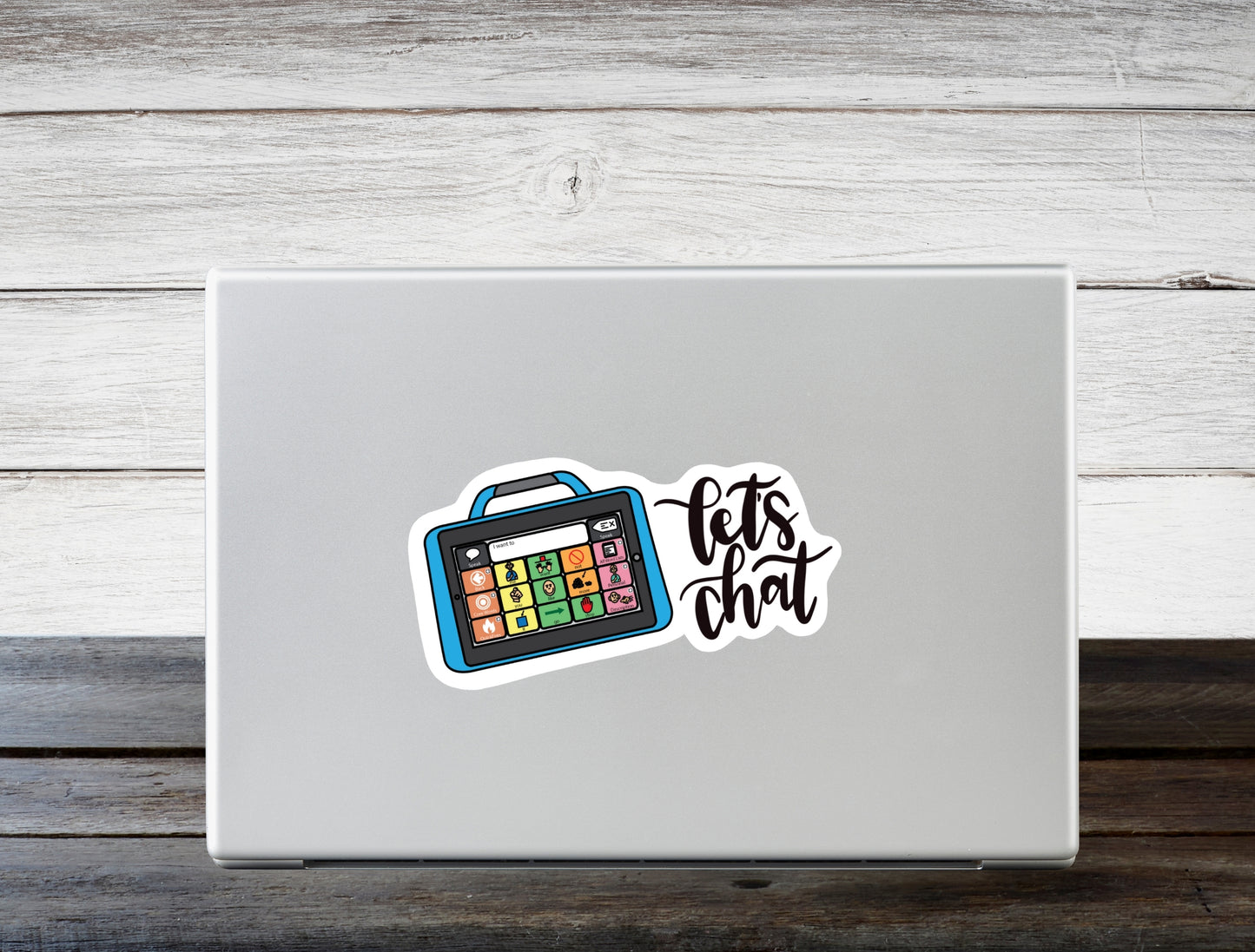 Let's chat written in handlettered script font. There is a high tech AAC device. This is a sticker. It is shown on the face/top of a laptop.